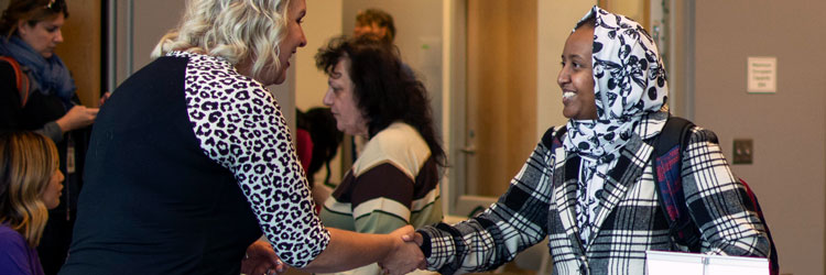 Recruiter and job seeker shaking hands at career fair