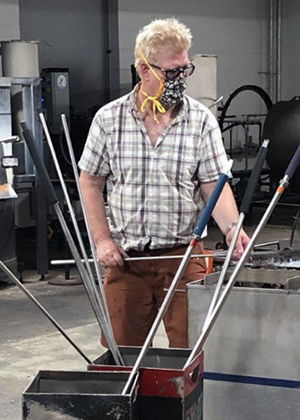 Bryan Etheir working in a glass shop.