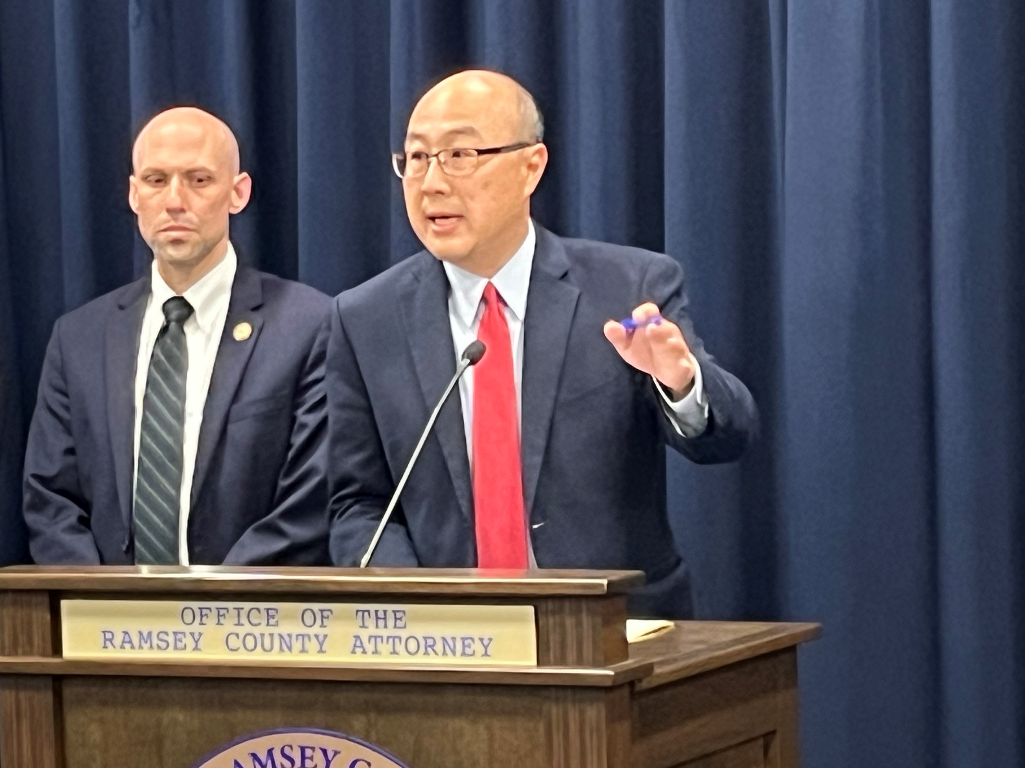 Ramsey County Attorney John Choi speaks from podium