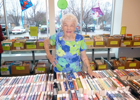 Smiling volunteer at the Pop-Up Used Book Sale