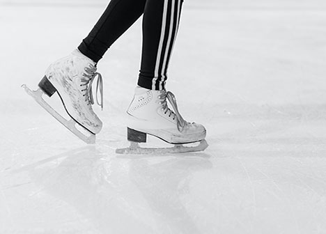 Close-up view of someone skating at an ice rink