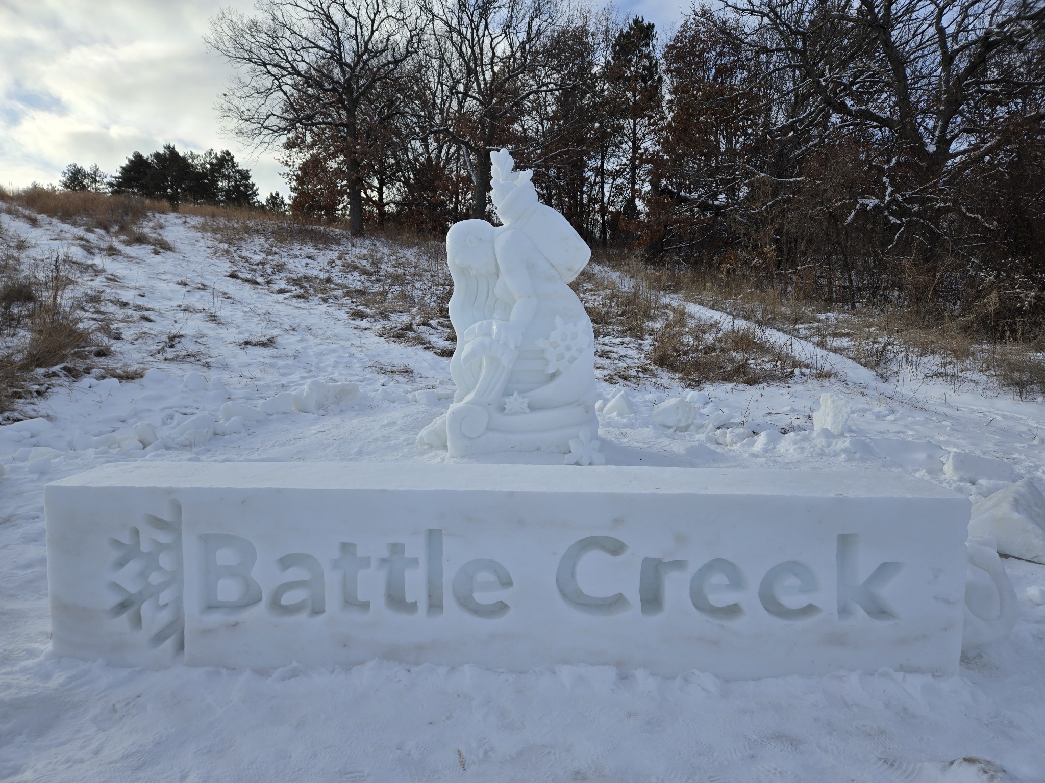 Snow sculpture of a woman kneeling in the snow at the Ramsey county Battle Creek Winter Recreation.