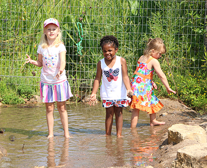 Day camp girls play at Discovery Hollow Nature Play Area Day camp girls play at Discovery Hollow Nature Play Area