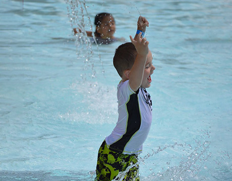 Happy child playing at a waterpark.