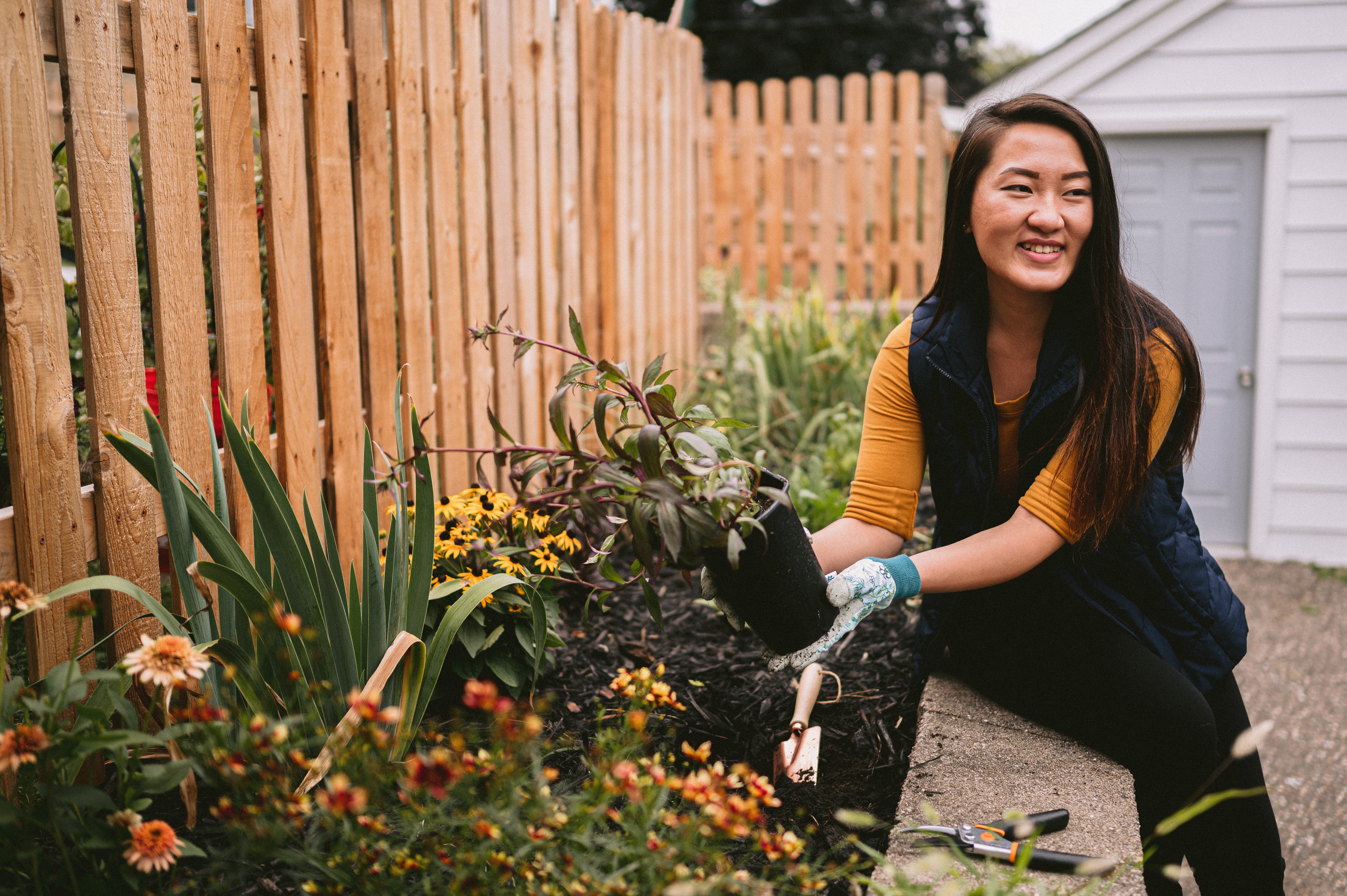 Woman holding soil in her garden.