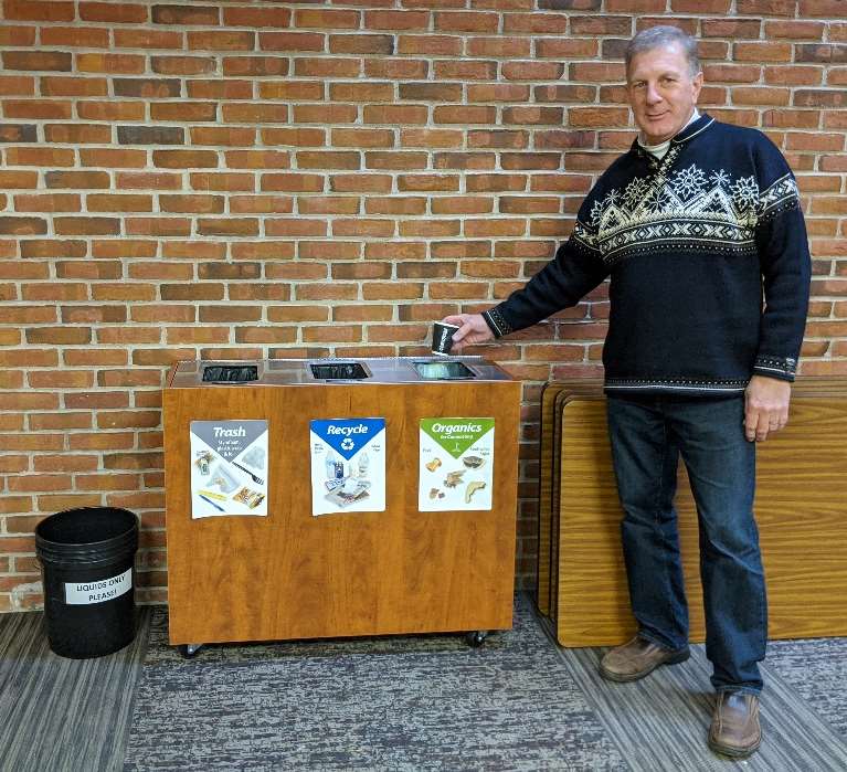 Man recycling a coffee cup at Trinity Lutheran Church