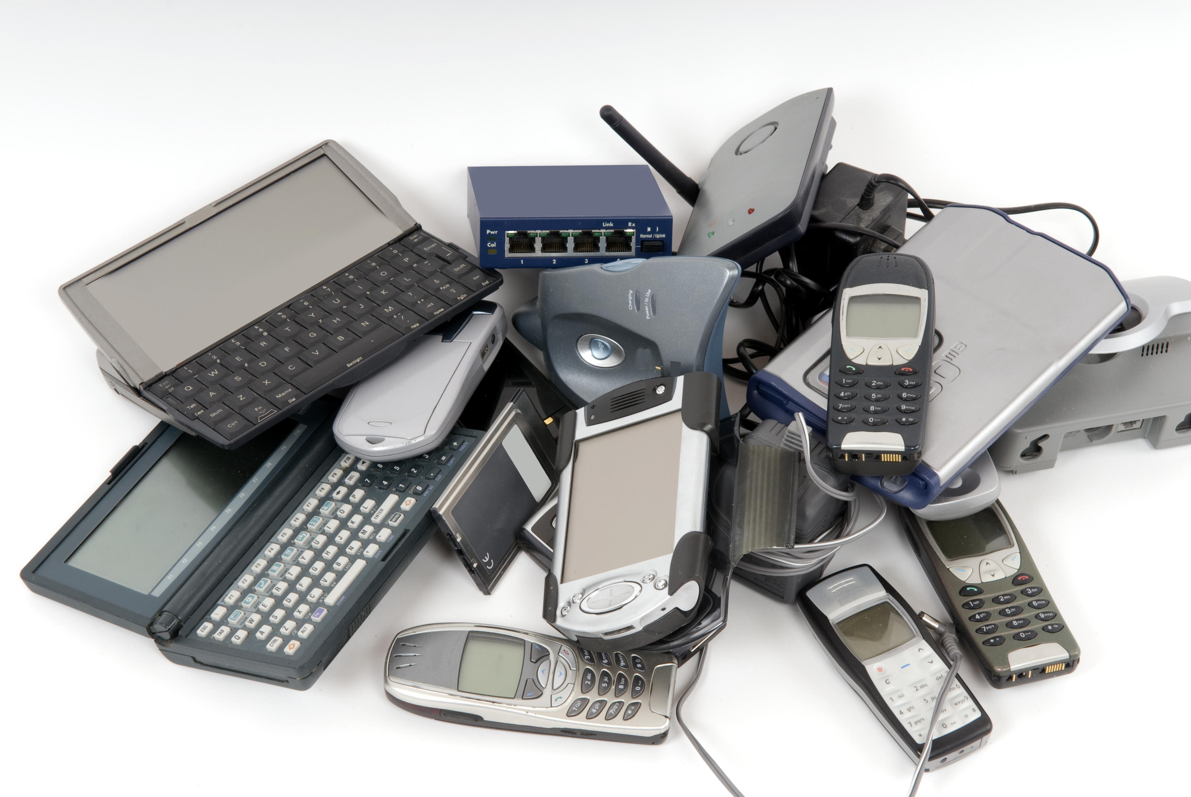 Computers, phones and other electronics in a pile