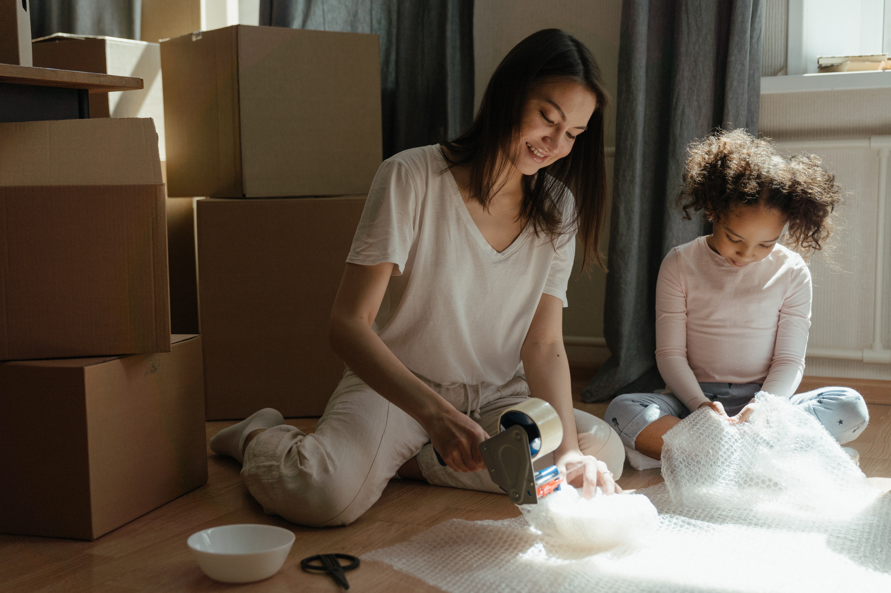 Mom and daughter packing up boxes