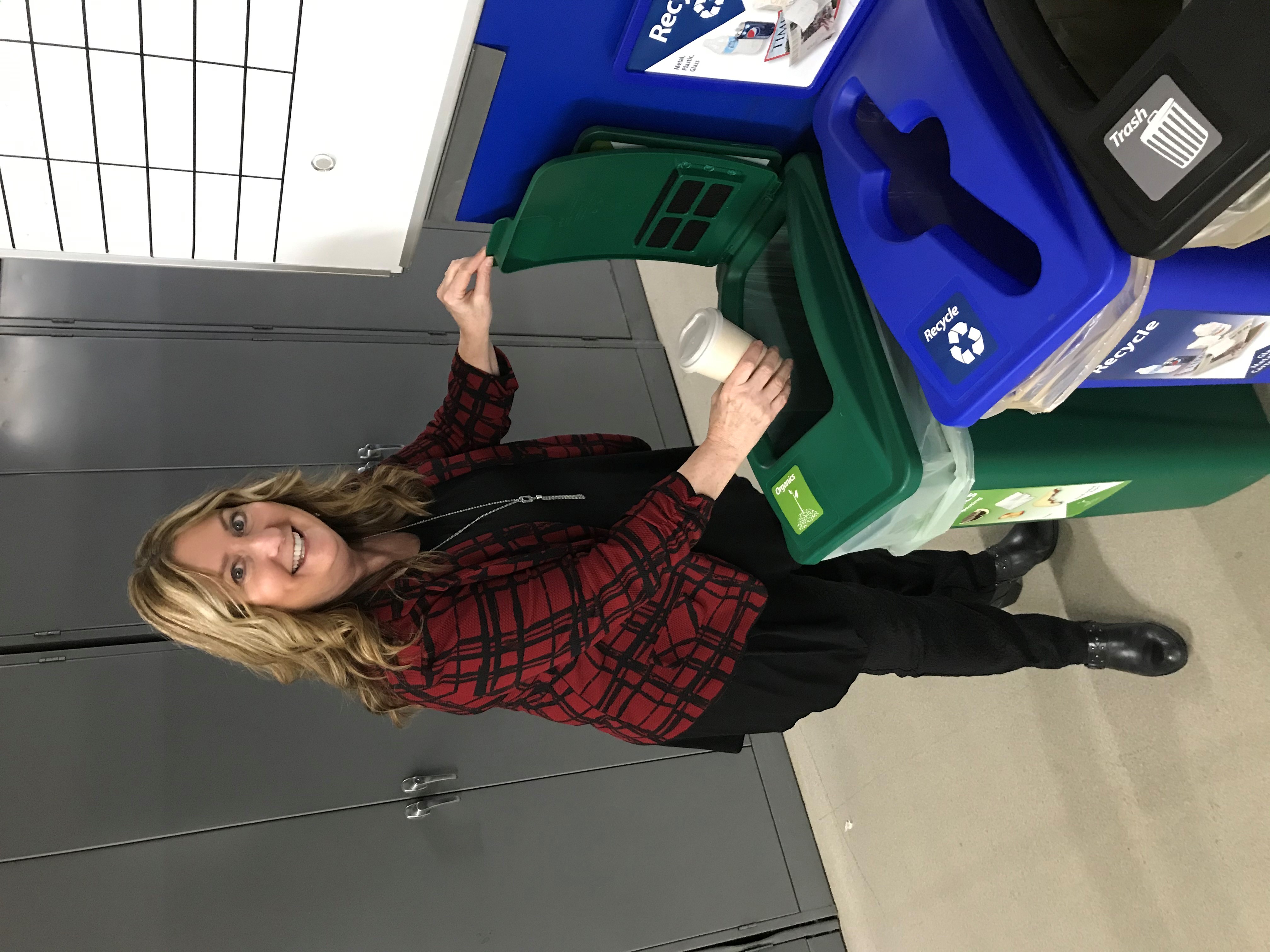 Woman recycling a coffee cup at Cummins Sales and Services 