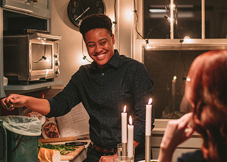 Couple preparing candlelit dinner