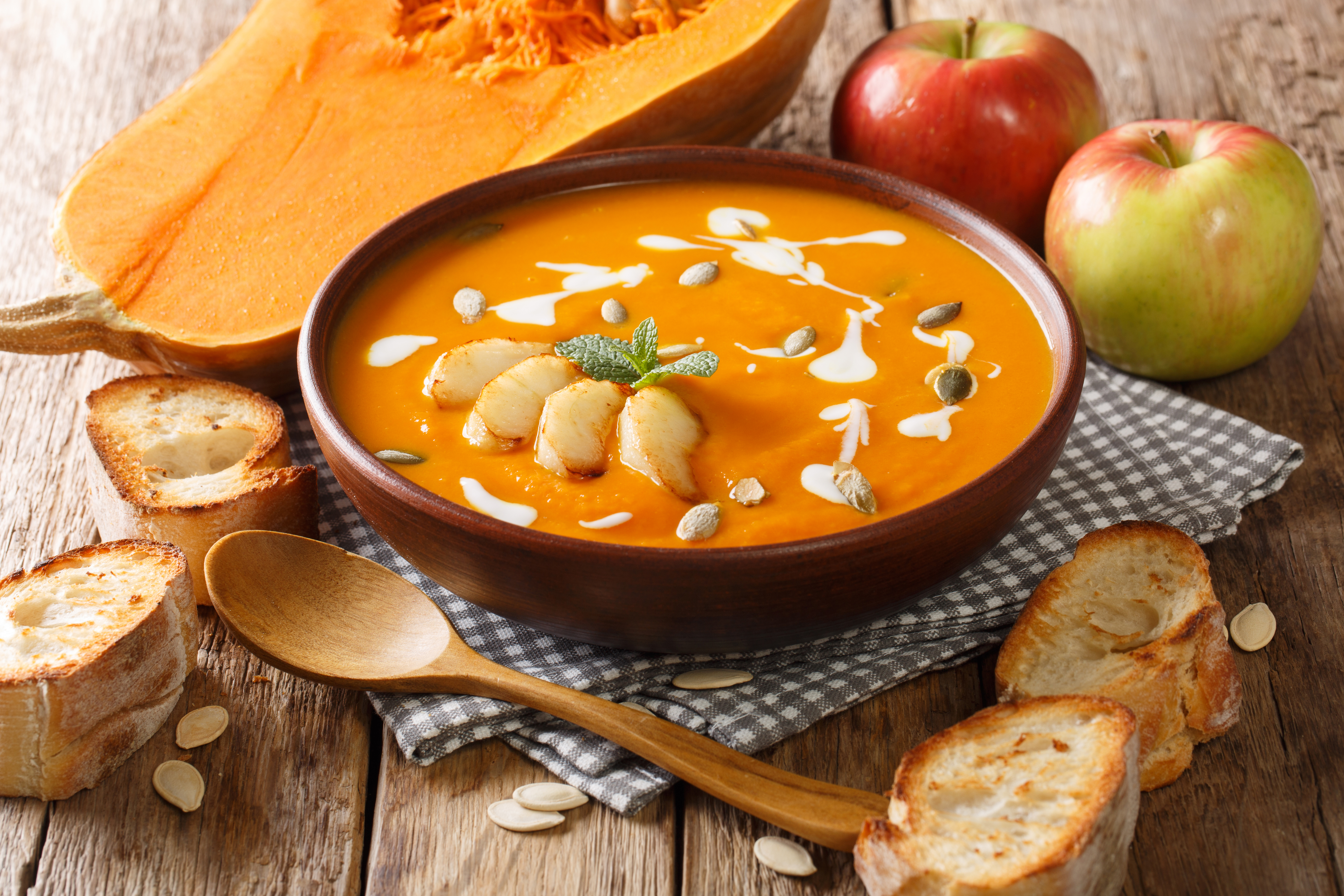 Pumpkin soup, cut apples and bread