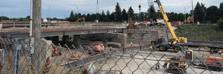 Construction crews removing beam from Dale Street bridge