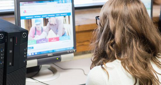 Woman filling out online application Woman filling out online application