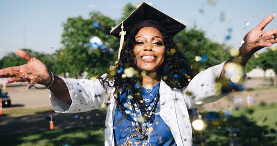 Graduate throwing confetti