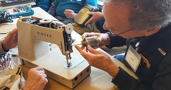 Volunteer fixing a sewing machine