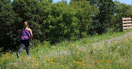 Girl walking on a nature path in the summer time