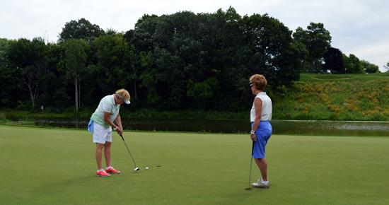 Women putting at Keller Golf Course