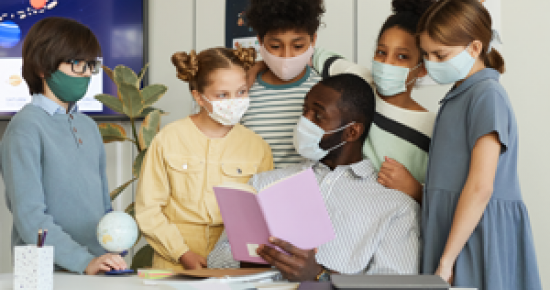 Group of elementary students in classroom wearing cloth face masks Group of elementary students in classroom wearing cloth face masks