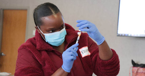 Public Health nurse preparing vaccine