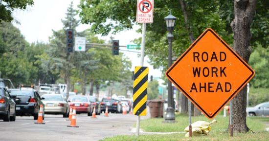 Road work ahead sign with lane of traffic